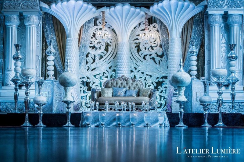 Carved white wedding stage backdrop with blue lighting by GPS Decors