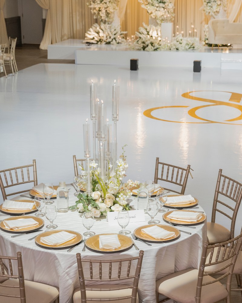 Reception table with tall candles and white florals by GPS Decors