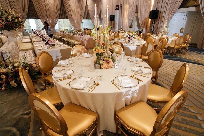 Ivory and gold reception tables with candle centrepieces at the Fairmont by GPS Decors