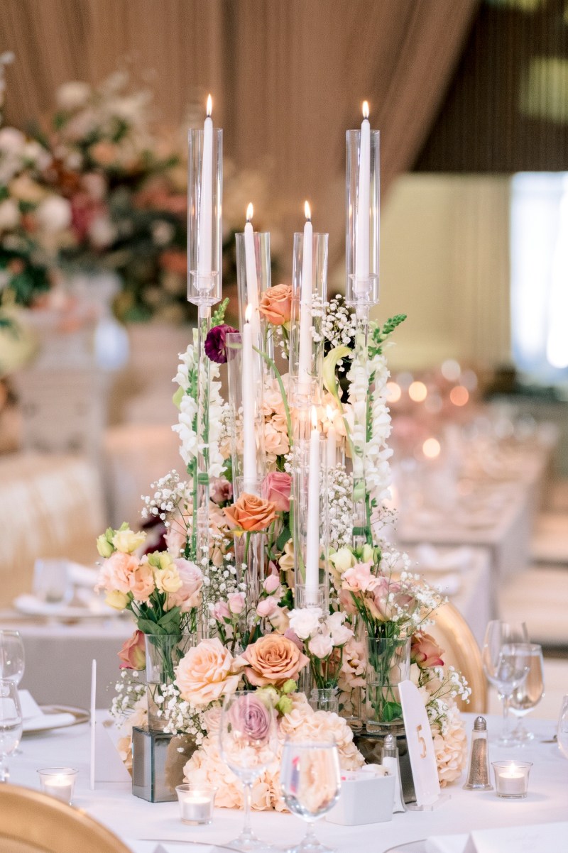 Tall taper candle centrepiece with peach and white roses at the Fairmont by GPS Decors