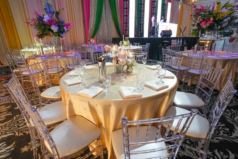 Jaago reception tables with gold linens and florals by GPS Decors