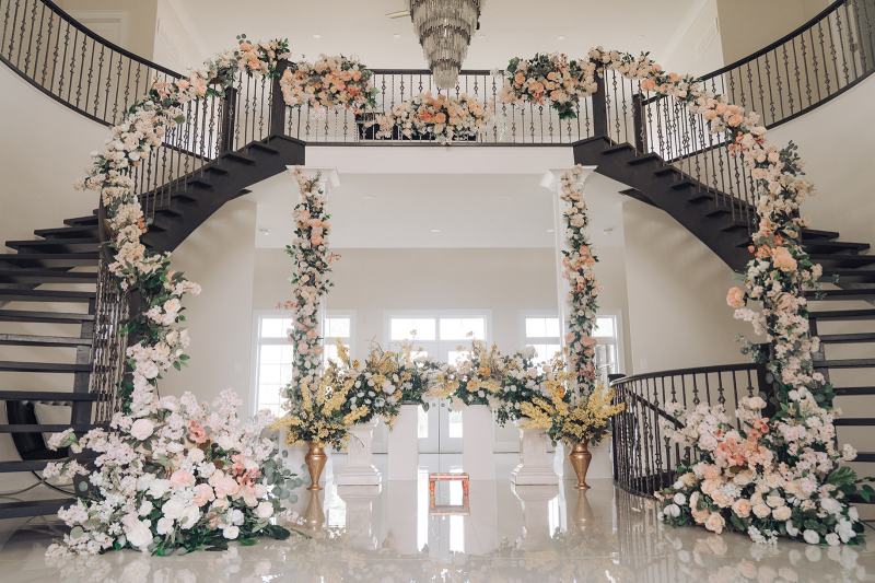 White and gold canopy stage framed with florals by GPS Decors