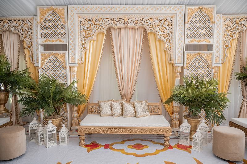 Maiyan stage with carved gold panels and mustard draping by GPS Decors