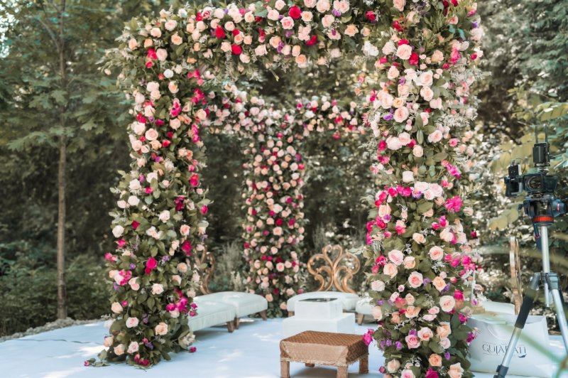 Outdoor garden mandap built from pillars of pink, white and red roses by GPS Decors