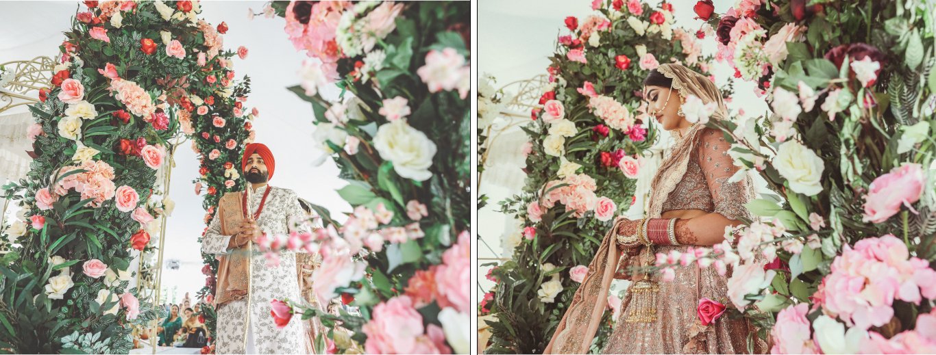 Bride framed by a lush pink, white and red rose floral arch by GPS Decors