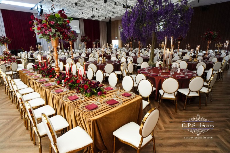 Ballroom reception with gold velvet linens and purple florals by GPS Decors