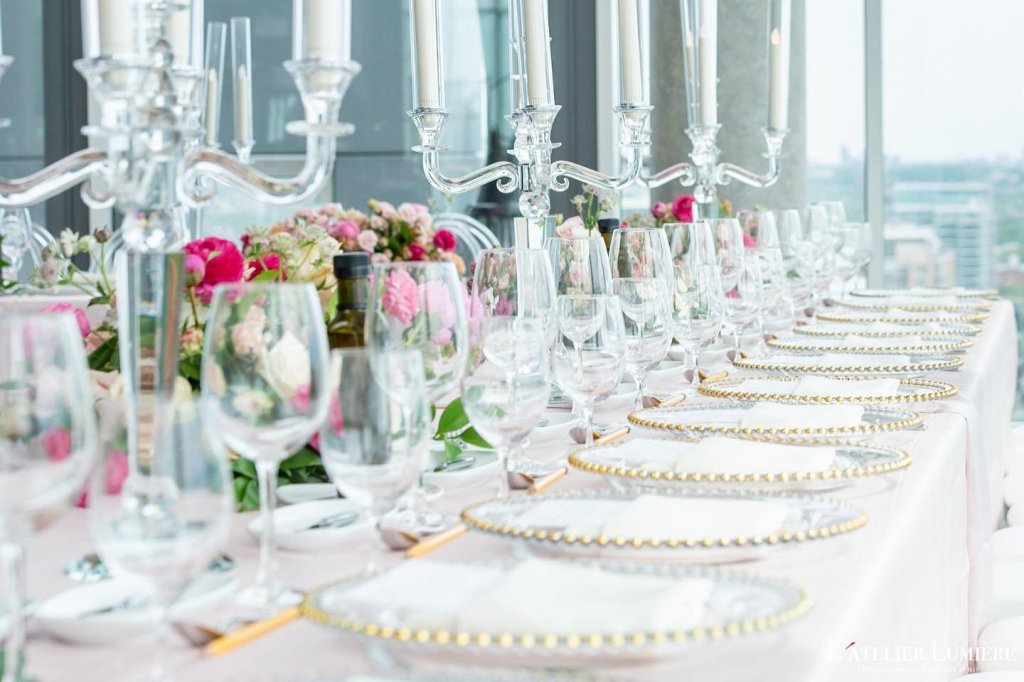 Elegant reception table with crystal glassware and a candelabra by GPS Decors
