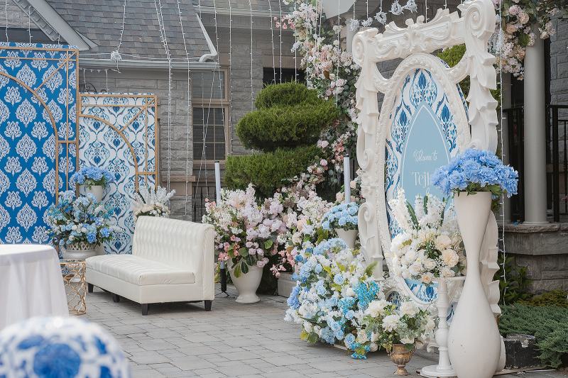 Sangeet entrance with blue and white floral arch by GPS Decors