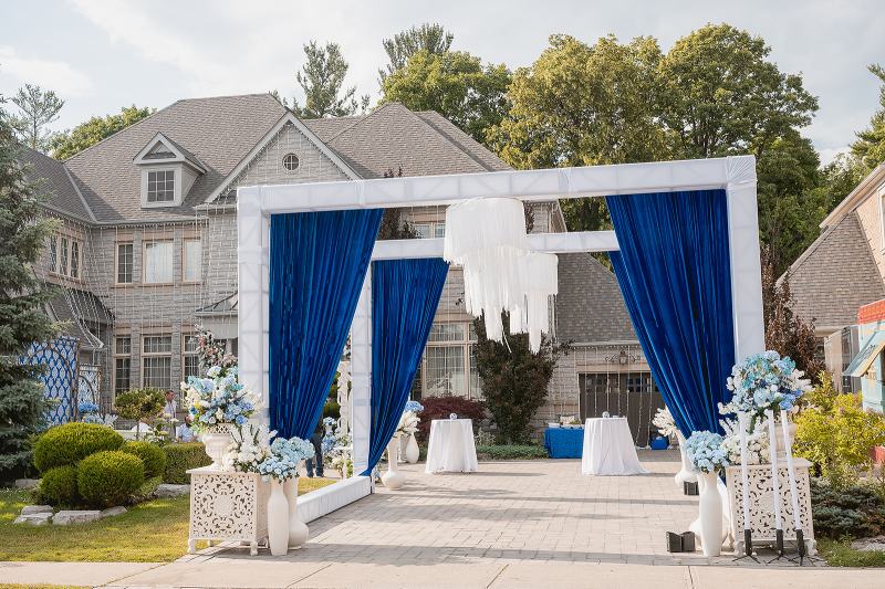 Outdoor sangeet stage with white frame and royal blue draping by GPS Decors