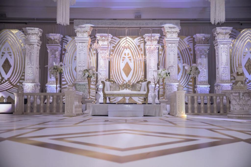 White carved wedding stage with marble-look floor by GPS Decors